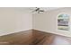 Bedroom with dark wood floors and natural light from a picturesque arched window at 13816 N 46Th St, Phoenix, AZ 85032