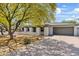 View of charming home with a two-car garage and drought tolerant landscaping at 13816 N 46Th St, Phoenix, AZ 85032