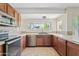 Well-lit kitchen with granite countertops, stainless steel appliances, and ample cabinet space at 13816 N 46Th St, Phoenix, AZ 85032