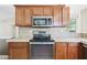 Modern kitchen with stainless steel appliances, tile backsplash, and plenty of counter space at 13816 N 46Th St, Phoenix, AZ 85032