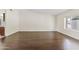 Bright and airy living room with wood floors and large window overlooking the yard at 13816 N 46Th St, Phoenix, AZ 85032