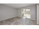 Neutral-toned bedroom with tile floors and a sliding glass door to a private patio at 14002 N 49Th Ave # 1040, Glendale, AZ 85306