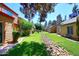 Beautiful community area featuring lush green landscaping, mature trees, and well-maintained exteriors of the homes at 14002 N 49Th Ave # 1040, Glendale, AZ 85306