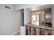 Kitchen bar featuring granite countertops, unique wood paneling, and convenient access to the outdoors at 14002 N 49Th Ave # 1040, Glendale, AZ 85306