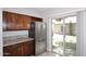 Kitchen with stainless steel refrigerator, wood cabinetry, granite counters and access to the backyard at 14002 N 49Th Ave # 1040, Glendale, AZ 85306