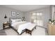 Serene bedroom with a comfortable bed, modern decor, and a sliding glass door leading to the backyard at 14002 N 49Th Ave # 1040, Glendale, AZ 85306