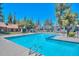 Community pool surrounded by lush greenery and lounge chairs, perfect for relaxing and enjoying the sunny weather at 14002 N 49Th Ave # 1040, Glendale, AZ 85306