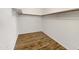 A walk-in closet space with wooden floors, shelving, and hanging bar at 1440 N Idaho Rd # 1048, Apache Junction, AZ 85119