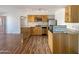 Well-appointed kitchen featuring ample wood cabinetry, granite countertops, and stainless steel appliances for modern living at 1440 N Idaho Rd # 1048, Apache Junction, AZ 85119