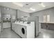Clean and functional community laundry room with multiple washers and folding table at 1440 N Idaho Rd # 1048, Apache Junction, AZ 85119