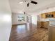 Bright living space featuring wood-style flooring, an open layout, and a view into the kitchen area at 1440 N Idaho Rd # 1048, Apache Junction, AZ 85119