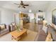 Open-concept living room features a ceiling fan, hardwood floors, and updated kitchen at 1440 N Idaho Rd # 1048, Apache Junction, AZ 85119
