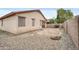 View of the home's backyard featuring a gravel area and block fence at 15339 W Jefferson St, Goodyear, AZ 85338