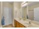 Bathroom with double sinks, framed mirror, neutral walls, and white doors to water closet and linen closet at 15339 W Jefferson St, Goodyear, AZ 85338