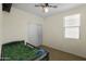 Cozy bedroom with closet, ceiling fan, window with blinds, and carpeted floors at 15339 W Jefferson St, Goodyear, AZ 85338