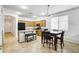 Open-concept kitchen with stainless steel appliances, a central island, and adjacent dining area at 15339 W Jefferson St, Goodyear, AZ 85338