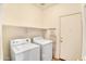 Laundry room featuring a washer, dryer, shelving and neutral walls at 15339 W Jefferson St, Goodyear, AZ 85338