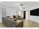 Cozy living room with a large sectional sofa, ceiling fan, and access to a patio at 15339 W Jefferson St, Goodyear, AZ 85338