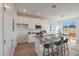 Modern kitchen features an island with seating, granite countertops, stainless steel appliances, and a sliding glass door at 18052 W Sand Hills Rd, Surprise, AZ 85387