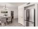 Bright dining area with modern chandelier, artwork, and stainless steel refrigerator at 19202 N 14Th St, Phoenix, AZ 85024