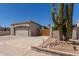Exterior view of home showcasing front yard landscaping, two-car garage, and painted facade at 19202 N 14Th St, Phoenix, AZ 85024