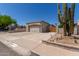 Single-story home featuring a two-car garage, desert landscaping, and a private front yard at 19202 N 14Th St, Phoenix, AZ 85024
