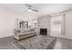 This living room features a cozy fireplace, tile flooring and neutral decor throughout the home at 19202 N 14Th St, Phoenix, AZ 85024