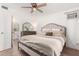 Comfortable main bedroom with neutral colors, ceiling fan, and natural light at 19202 N 14Th St, Phoenix, AZ 85024