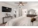 Bright main bedroom with ceiling fan, TV, and ensuite bathroom at 19202 N 14Th St, Phoenix, AZ 85024