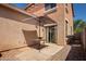 Backyard patio area with a table, sun umbrella, patio pavers, and rock landscaping at 1968 E Emily Ln, Gilbert, AZ 85295