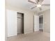 Cozy bedroom featuring a ceiling fan and large closet with sliding doors at 1968 E Emily Ln, Gilbert, AZ 85295