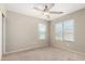 Bedroom features a ceiling fan and two windows, providing ample lighting at 1968 E Emily Ln, Gilbert, AZ 85295
