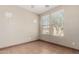 This bedroom features tile flooring and multiple windows, offering plenty of natural light at 1968 E Emily Ln, Gilbert, AZ 85295