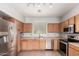 Well-lit kitchen showcasing stainless steel appliances and ample wood cabinetry at 1968 E Emily Ln, Gilbert, AZ 85295