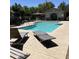 Community pool area with lounge chairs and a small pool house at 1968 E Emily Ln, Gilbert, AZ 85295
