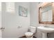 Charming powder room features a modern sink, stylish mirror, and decorative wall art at 1968 E Emily Ln, Gilbert, AZ 85295