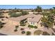 An aerial view of this delightful home shows the tiled roof, desert landscaping, and convenient three-car garage at 19714 N Rim Dr, Surprise, AZ 85374