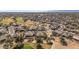 Wide aerial perspective showcasing a desert residential area adjacent to a golf course under clear sky at 19714 N Rim Dr, Surprise, AZ 85374
