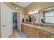 Bathroom with double sinks, granite counters, walk-in closet at 19714 N Rim Dr, Surprise, AZ 85374