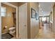 Well-lit half bath with framed artwork and views into the kitchen and living room at 19714 N Rim Dr, Surprise, AZ 85374