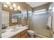Well-lit bathroom features a vanity with a white countertop and a glass-enclosed shower at 19714 N Rim Dr, Surprise, AZ 85374