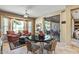 Bright breakfast nook with table, chairs, and bay window overlooking backyard patio at 19714 N Rim Dr, Surprise, AZ 85374