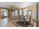 Dining room features a round glass table, decorative rug, and neutral tones, seamlessly connecting to other living areas at 19714 N Rim Dr, Surprise, AZ 85374