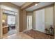 Spacious foyer features tile flooring, a front door, and arched doorway leading to the cozy living room at 19714 N Rim Dr, Surprise, AZ 85374