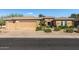 Charming single-story home featuring desert landscaping, a tile roof, and a spacious three-car garage at 19714 N Rim Dr, Surprise, AZ 85374