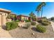Attractive single-story home with desert landscaping, palm trees, and decorative planters by the driveway at 19714 N Rim Dr, Surprise, AZ 85374