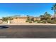 Inviting single-story home boasting lush desert landscaping and a spacious three-car garage at 19714 N Rim Dr, Surprise, AZ 85374