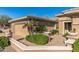 Charming exterior view of a single story home with lush landscaping and an inviting courtyard area at 19714 N Rim Dr, Surprise, AZ 85374