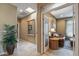 Hallway featuring a neutral color palette and tile flooring, leading to a study and other living spaces at 19714 N Rim Dr, Surprise, AZ 85374