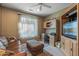 Well-lit home office with built-in desk, comfortable seating, and ample natural light at 19714 N Rim Dr, Surprise, AZ 85374